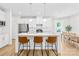 Modern kitchen features an island with seating, stainless steel appliances, and pendant lighting at 3110 Streamside Dr, Davidson, NC 28036