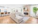 Open-concept living area with stone fireplace, white sectional, and access to the kitchen at 3110 Streamside Dr, Davidson, NC 28036
