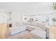 Spacious open-concept living area with white sectional sofa and hardwood floors at 3110 Streamside Dr, Davidson, NC 28036