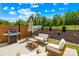 Outdoor patio area featuring a grill, seating, and lush landscaping at 3110 Streamside Dr, Davidson, NC 28036