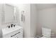 Stylish powder room featuring a decorative mirror, modern fixtures, and a sleek vanity at 3110 Streamside Dr, Davidson, NC 28036