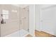 Sleek glass shower enclosure with modern tile, hardware and convenient shelving for toiletries in bathroom at 3110 Streamside Dr, Davidson, NC 28036