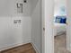 Hallway featuring laundry closet leading to a bedroom with a luxurious bed and stylish decor at 3124 Butler Hill Dr, Matthews, NC 28105