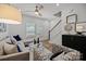 Cozy living area with hardwood floors, a sectional sofa, and abundant natural light at 3124 Butler Hill Dr, Matthews, NC 28105