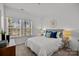 Bright bedroom showcasing a comfortable bed, two windows, and elegant decor at 3128 Butler Hill Dr, Matthews, NC 28105