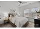 Bright bedroom featuring a ceiling fan, plush bedding, and natural light from a large window at 3128 Butler Hill Dr, Matthews, NC 28105