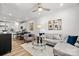 Bright open-concept living room featuring modern decor, a plush sofa, and seamless access to the kitchen at 3128 Butler Hill Dr, Matthews, NC 28105