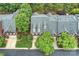 Aerial view of a red brick townhome with a gray shingle roof and mature trees at 3128 Ethereal Ln, Charlotte, NC 28226