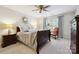 Comfortable bedroom with a cozy bed, wooden furniture, ceiling fan, and neutral decor at 3128 Ethereal Ln, Charlotte, NC 28226