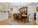 Elegant dining room with hardwood floors, decorative columns, and stylish furniture at 3128 Ethereal Ln, Charlotte, NC 28226