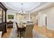 Elegant dining room with hardwood floors, decorative columns, and stylish furniture at 3128 Ethereal Ln, Charlotte, NC 28226