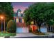 Charming red brick two-story home featuring a three-car garage and lush landscaping at 3128 Ethereal Ln, Charlotte, NC 28226