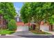 Charming red brick two-story home featuring a three-car garage and lush landscaping at 3128 Ethereal Ln, Charlotte, NC 28226