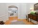 Warm hallway showcasing hardwood floors and classic trim with entry to formal living spaces at 3128 Ethereal Ln, Charlotte, NC 28226