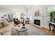 Bright living room showcasing a fireplace, large windows, and stylish furnishings at 3128 Ethereal Ln, Charlotte, NC 28226