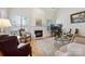 Bright living room showcasing a fireplace, large windows, and stylish furnishings at 3128 Ethereal Ln, Charlotte, NC 28226