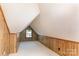 Finished attic space with wood paneled walls, carpet flooring, and a window for natural light at 328 E Center Ave, Mooresville, NC 28115