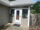 Exterior view of back entrance with a concrete patio and plants at 328 E Center Ave, Mooresville, NC 28115