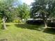 Fenced backyard featuring mature trees and a well-maintained lawn at 328 E Center Ave, Mooresville, NC 28115