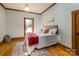 Charming bedroom featuring wood floors, a decorative rug, and abundant natural light from the window at 328 E Center Ave, Mooresville, NC 28115