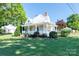 Charming home with a landscaped lawn and front porch offers a blend of comfort and curb appeal on a sunny day at 328 E Center Ave, Mooresville, NC 28115