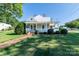 Charming home featuring a landscaped front yard, brick pathway, and inviting front porch, perfect for relaxation at 328 E Center Ave, Mooresville, NC 28115