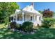 Charming home featuring a landscaped lawn, manicured bushes and inviting front porch, perfect for enjoying a peaceful setting at 328 E Center Ave, Mooresville, NC 28115