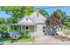 Charming home featuring a covered front porch, beautiful landscaping, and a metal roof at 328 E Center Ave, Mooresville, NC 28115