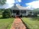 Charming home featuring a cozy front porch, brick steps, and mature landscaping at 328 E Center Ave, Mooresville, NC 28115