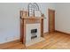 Vintage decorative fireplace featuring hardwood floors, classic mantel, and bright natural light at 328 E Center Ave, Mooresville, NC 28115