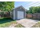 Detached garage with white door and a concrete pad, providing ample parking and storage space to the property at 328 E Center Ave, Mooresville, NC 28115