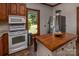 A charming kitchen featuring an island, granite countertops, and appliances at 328 E Center Ave, Mooresville, NC 28115
