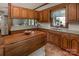 A charming kitchen featuring an island, granite countertops, and wood cabinetry at 328 E Center Ave, Mooresville, NC 28115