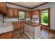 A charming kitchen featuring an island, granite countertops, and wood cabinetry at 328 E Center Ave, Mooresville, NC 28115