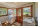 Bright laundry room with a washer, dryer, and multiple windows offering natural light at 328 E Center Ave, Mooresville, NC 28115