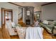 Comfortable living room featuring a stone fireplace, hardwood floors, and classic furnishings at 328 E Center Ave, Mooresville, NC 28115