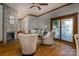 Cozy living room with a stone fireplace, hardwood floors, and lots of natural light from sliding glass doors at 328 E Center Ave, Mooresville, NC 28115