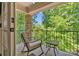 Inviting balcony with stone columns and serene views of lush greenery at 335 Whisper Lake Dr, New London, NC 28127