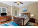 Cozy bedroom with nautical decor, wood furniture, and natural light at 335 Whisper Lake Dr, New London, NC 28127