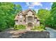 Stunning stone and stucco home with manicured landscaping and a circular driveway at 335 Whisper Lake Dr, New London, NC 28127