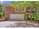 Spacious two-car garage and covered patio with outdoor entertainment space at 335 Whisper Lake Dr, New London, NC 28127