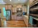Gourmet kitchen with custom cabinets, stainless steel appliances, and granite countertops at 335 Whisper Lake Dr, New London, NC 28127