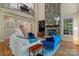 Open-concept living room with stone fireplace, hardwood floors, and a view of the upper balcony at 335 Whisper Lake Dr, New London, NC 28127