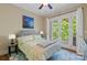 Serene bedroom with a private balcony overlooking the trees at 335 Whisper Lake Dr, New London, NC 28127