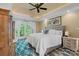 Bright main bedroom with tray ceilings, french doors, and a plush bed at 335 Whisper Lake Dr, New London, NC 28127
