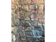 Close-up of an outdoor shower with natural stone surround, adding a rustic touch to the landscape at 335 Whisper Lake Dr, New London, NC 28127