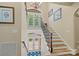 Elegant staircase with hardwood steps and wrought iron railing leading to the upper level at 335 Whisper Lake Dr, New London, NC 28127