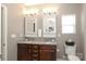 Bathroom featuring double vanity with granite countertops, two mirrors and white cabinets and lighting, offering ample storage at 363 Bellingrath Blvd, Rock Hill, SC 29730