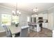 Bright kitchen with a dining area, white cabinetry, stainless steel appliances, and granite countertops at 363 Bellingrath Blvd, Rock Hill, SC 29730