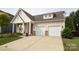 Beautiful home with a two-car garage, stone accents, lush lawn, and manicured landscaping at 363 Bellingrath Blvd, Rock Hill, SC 29730